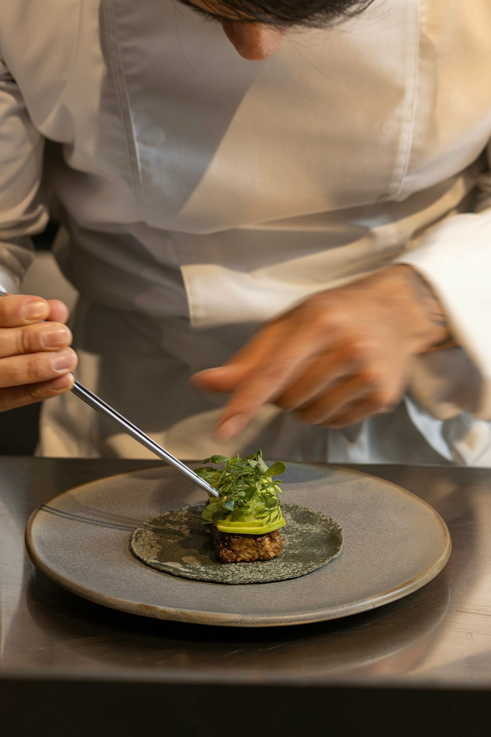 A longevity chef plating a healthy dish